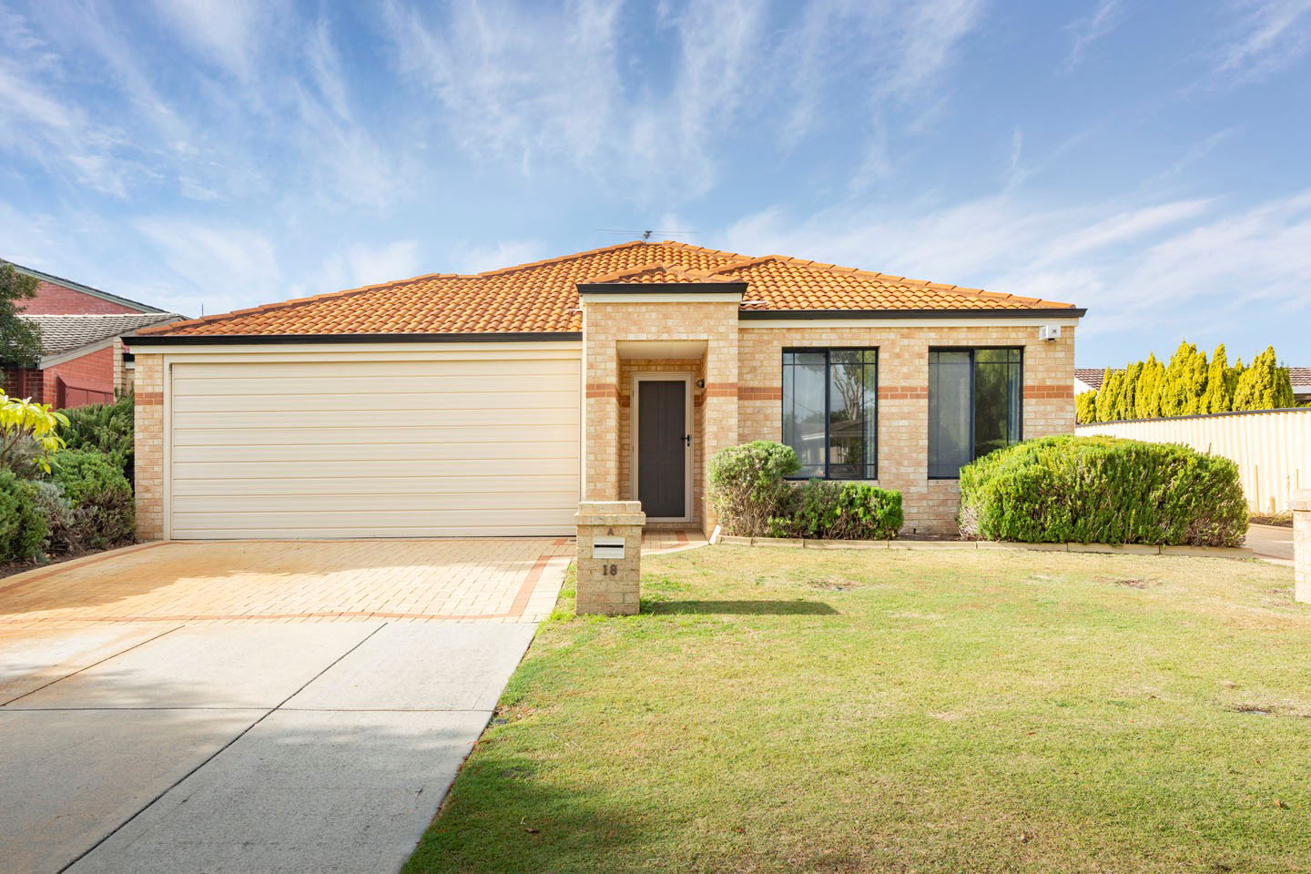 Modern suburban house with lawn and driveway.