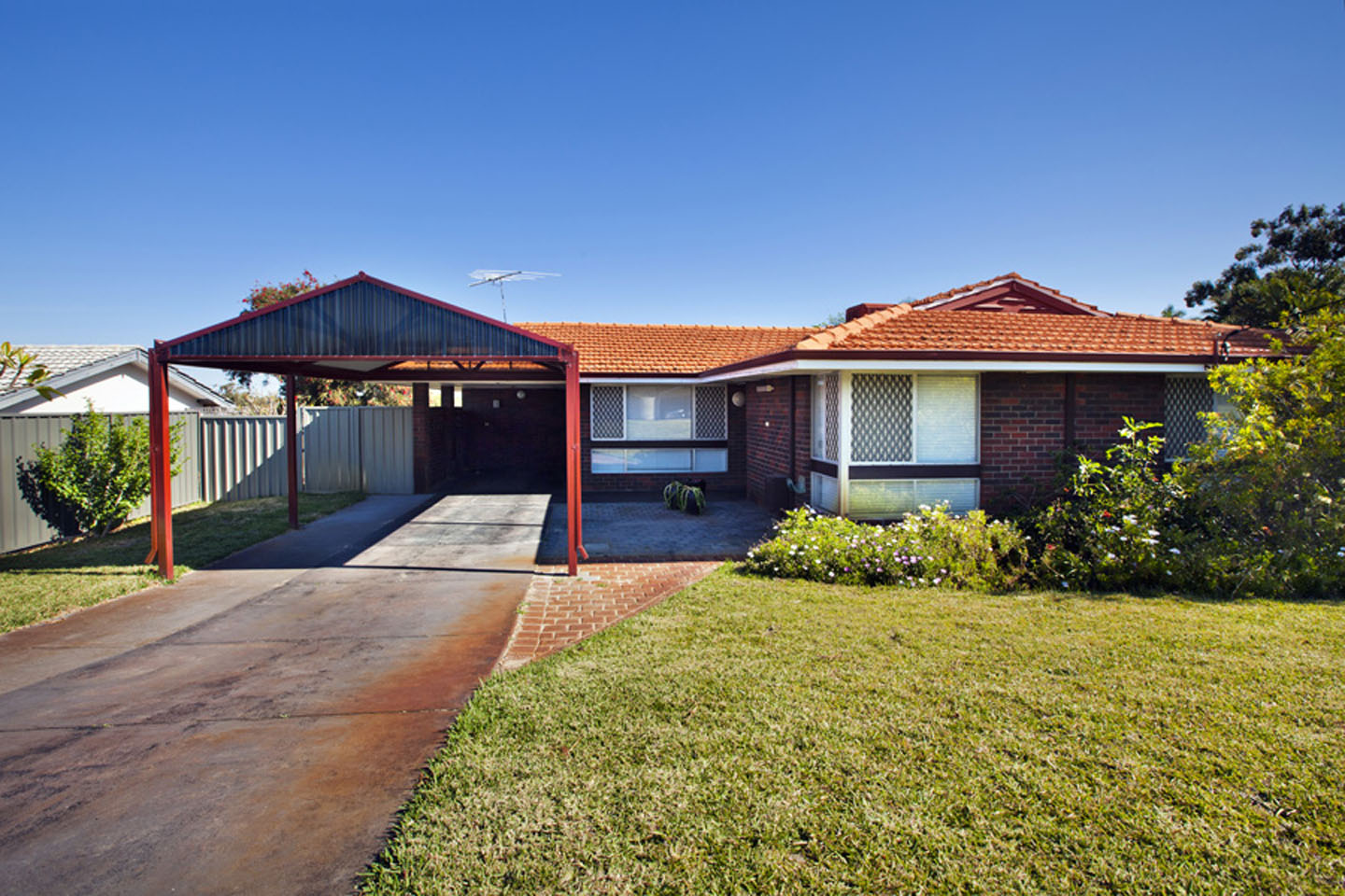 Single-story brick house with carport and lawn