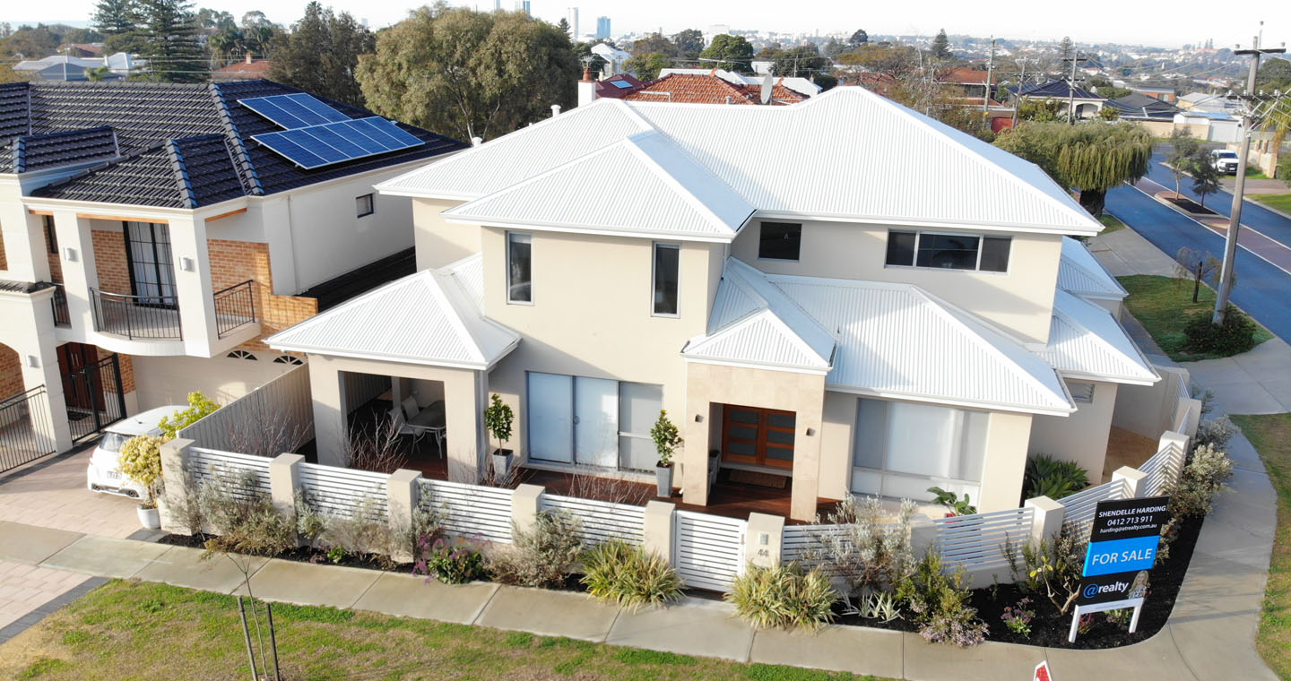 Two-story house with solar panels for sale.