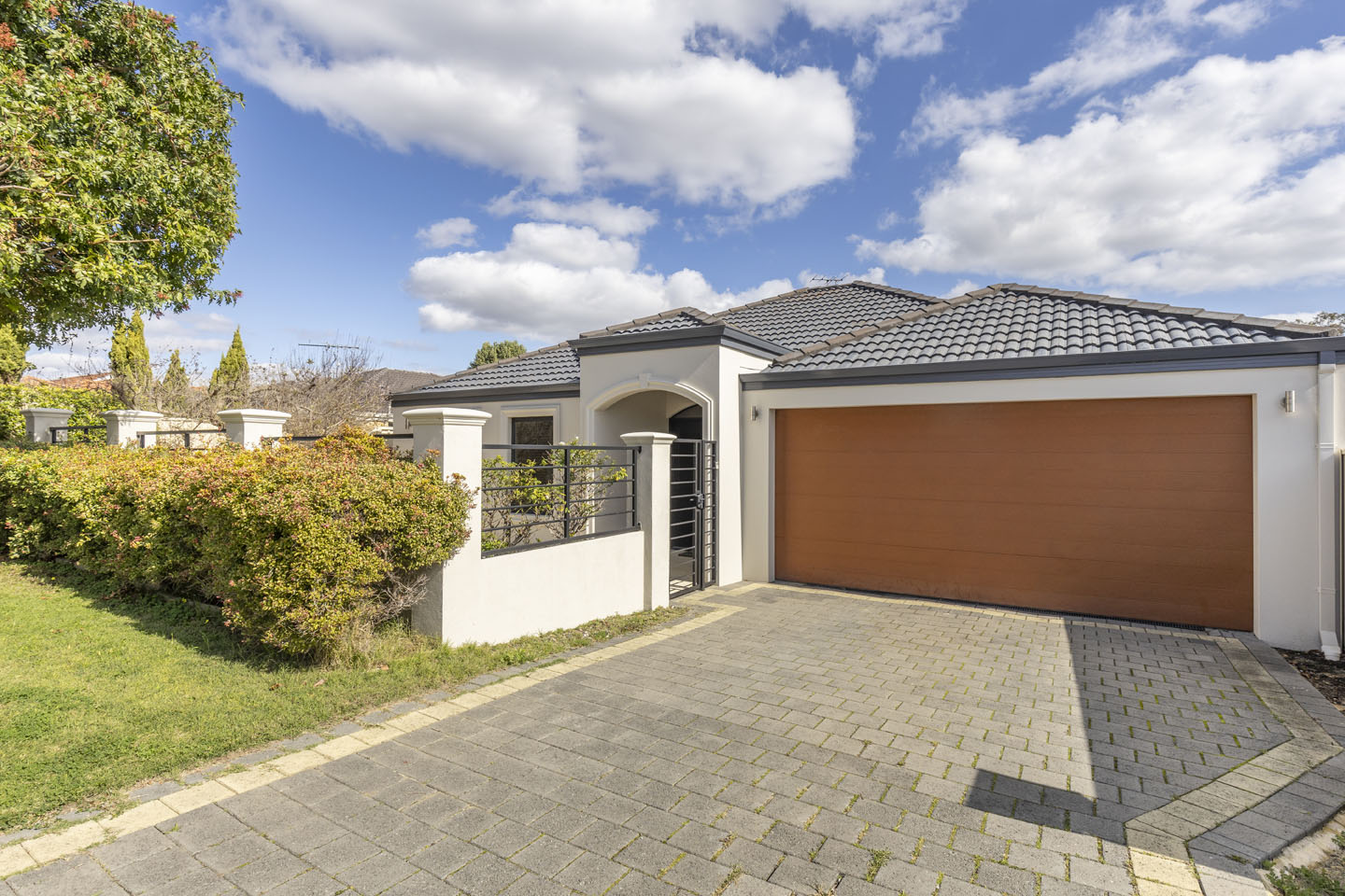 Modern house with gray roof and garage door.