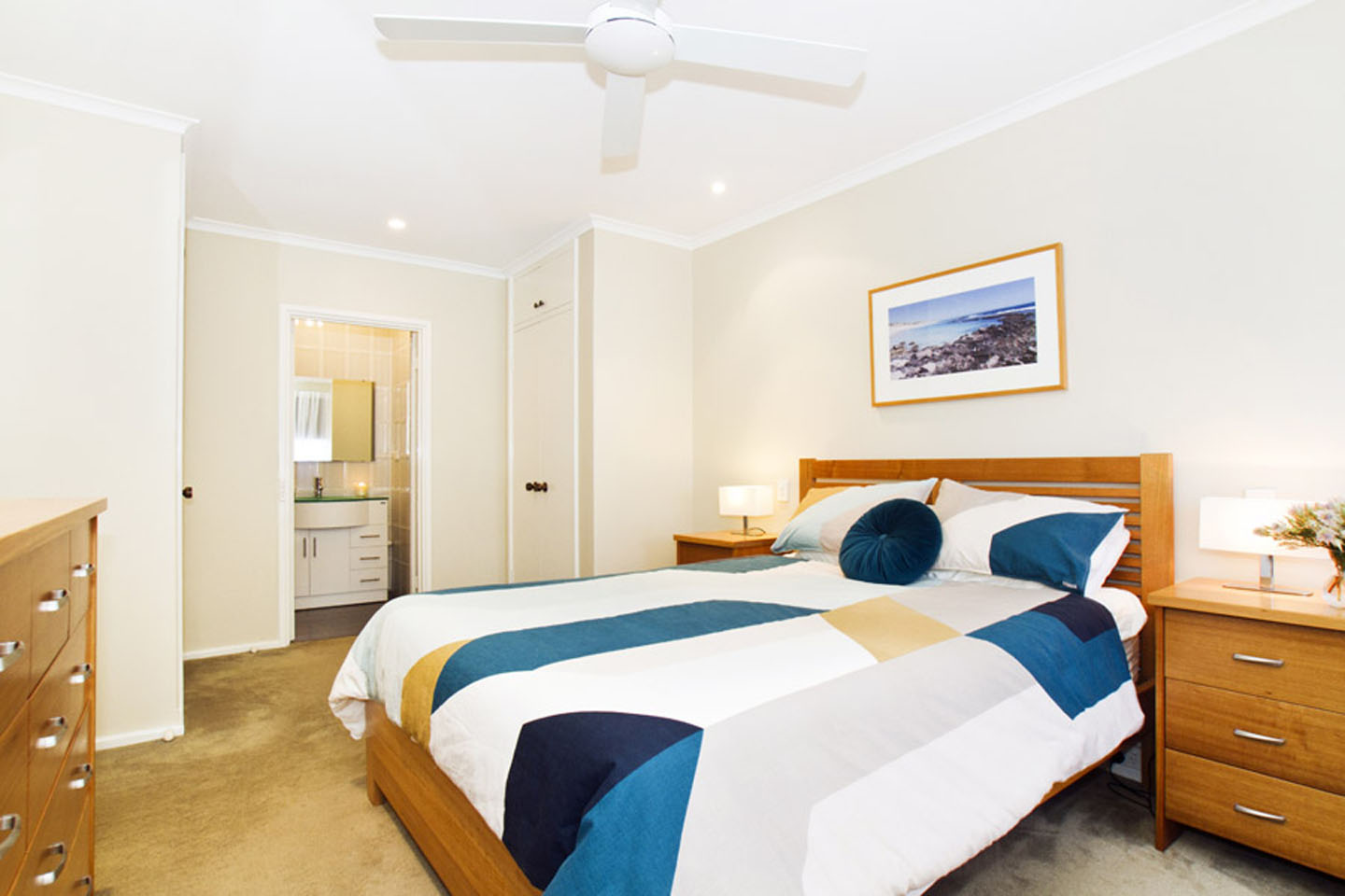 Cozy bedroom with modern decor and ensuite bathroom.